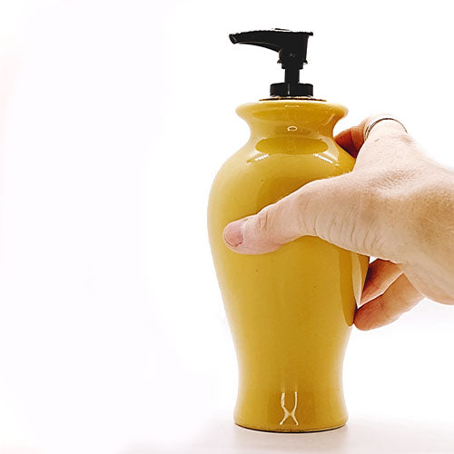 Yellow ceramic vase turned soap dispenser